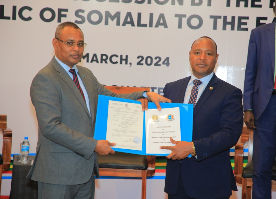 EAC Secretary General, Hon. (Dr.) Peter Mathuki (right), receives the Federal Republic of Somalia’s instrument of ratification of the Treaty of Accession to EAC from Somalia’s Minister of Commerce and Industry, Hon. Jibril Abdirashid Haji Abdi, at the EAC Headquarters in Arusha, Tanzania.
