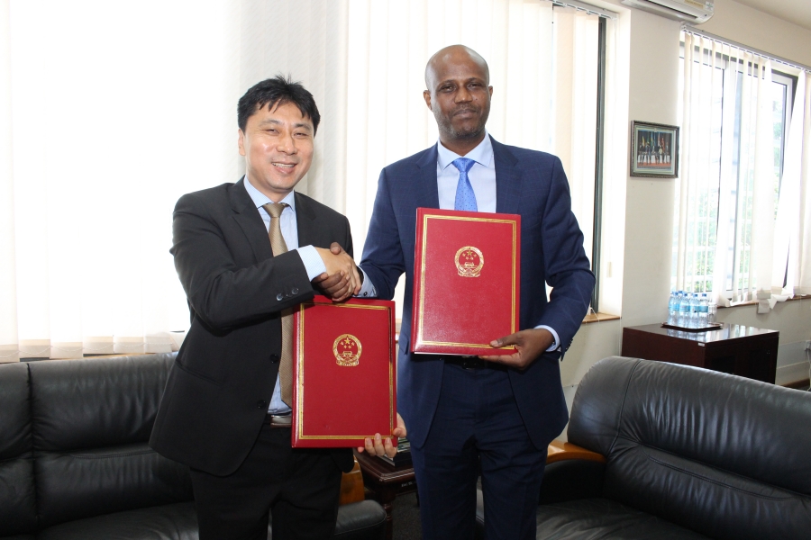 The Political Counselor at the Chinese Embassy in Dar es Salaam, Mr. Liang Lin, exchanging particulars with the EAC Secretary General Amb. Liberat Mfumukeko after the two signed the framework agreement under which China has granted EAC US$200,000 to support various capacity building programmes.