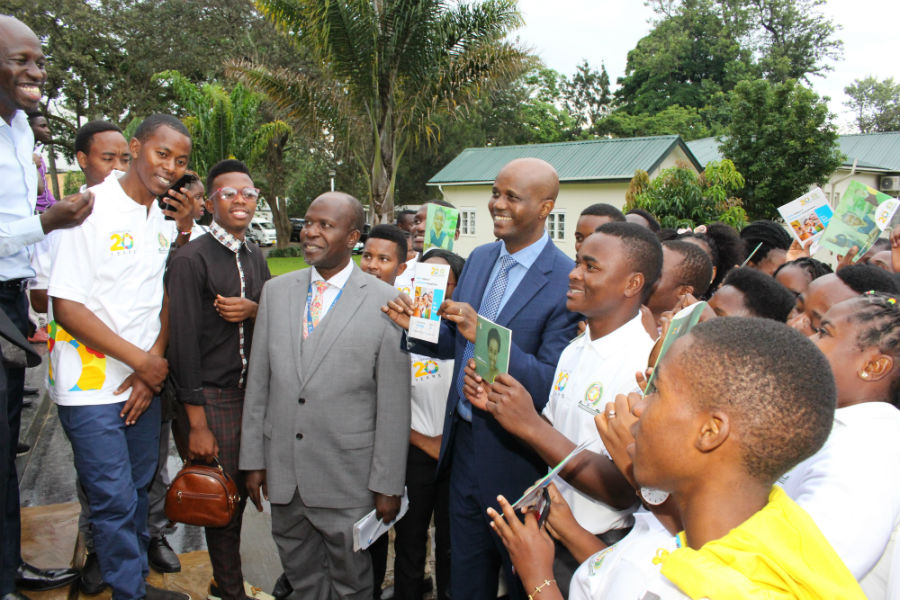EAC Secretary General Amb. Liberat Mfumukeko (centre), Director of Trade Alhaji Rashid Kibowa (in grey suit), and participants hold campaign booklets shortly after the launch outside the EAC Headquarters.
