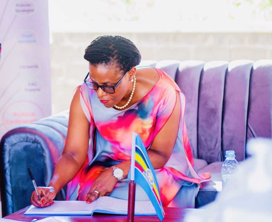 The EAC Deputy Secretary General in charge of Customs, Trade and Monetary Affairs, Ms. Annette Ssemuwemba, sign the visitor’s book at the East African Court of Justice booth during the 24th MSMEs Forum in Juba.