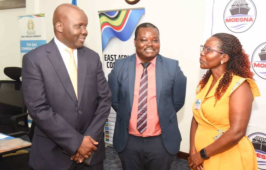 The EAC Deputy Secretary General in charge of the Infrastructure, Productive, Social and Political Sectors, Hon. Andrea Aguer Ariik Malueth (left), confers with Eng. Godfrey Enzama, Principal Civil Engineer at the EAC Secretariat, and a delegate during the opening session of the 19th Sectoral Council on Transport, Communications and Meteorology.